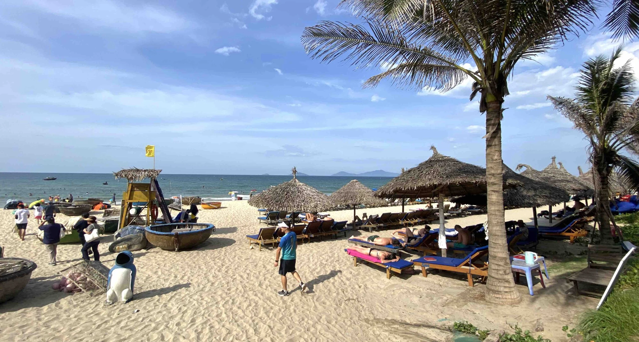 Tourists sun bathing in Cam An beach