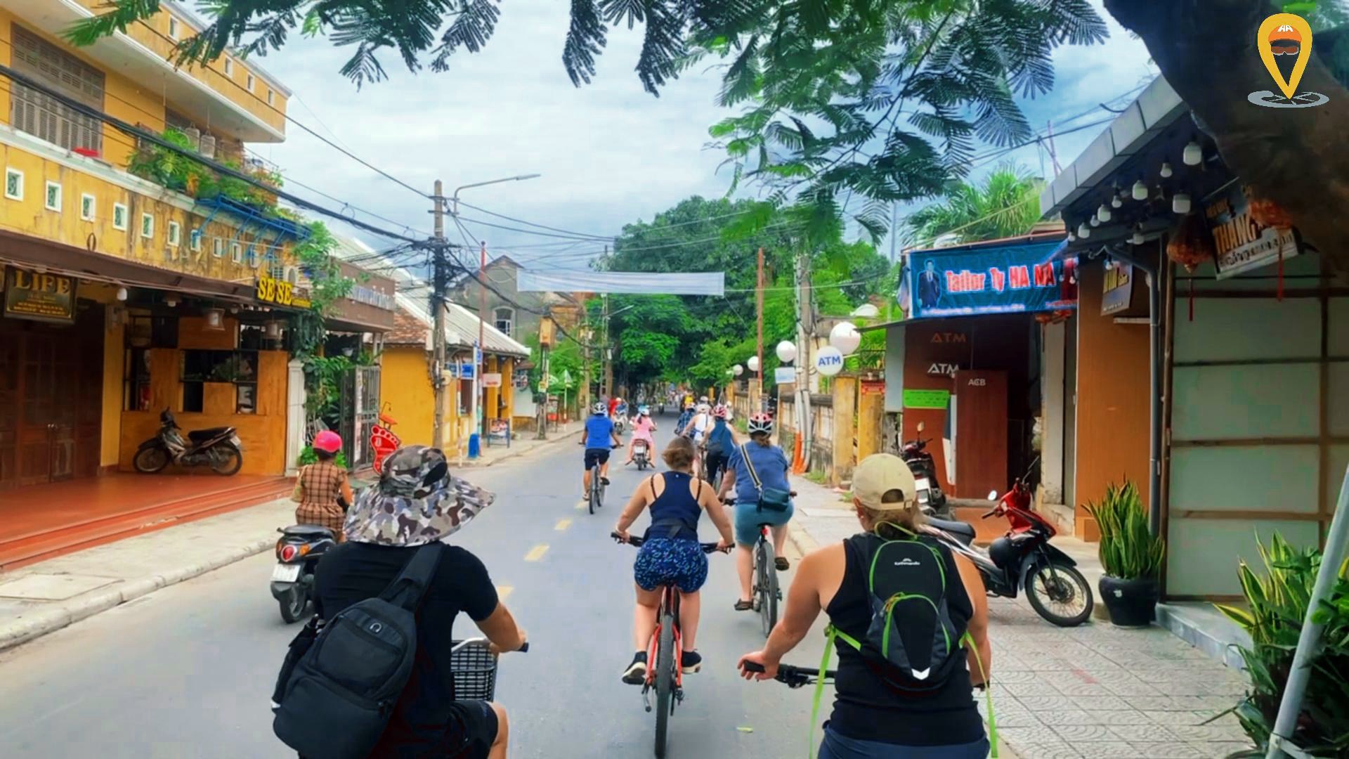 Tourists with mountain bikes in the streets of Hoi An