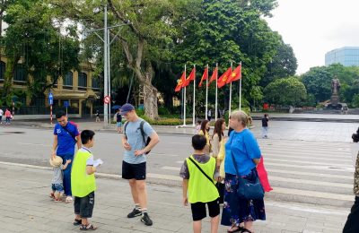 Children taking with tourists in Hanoi