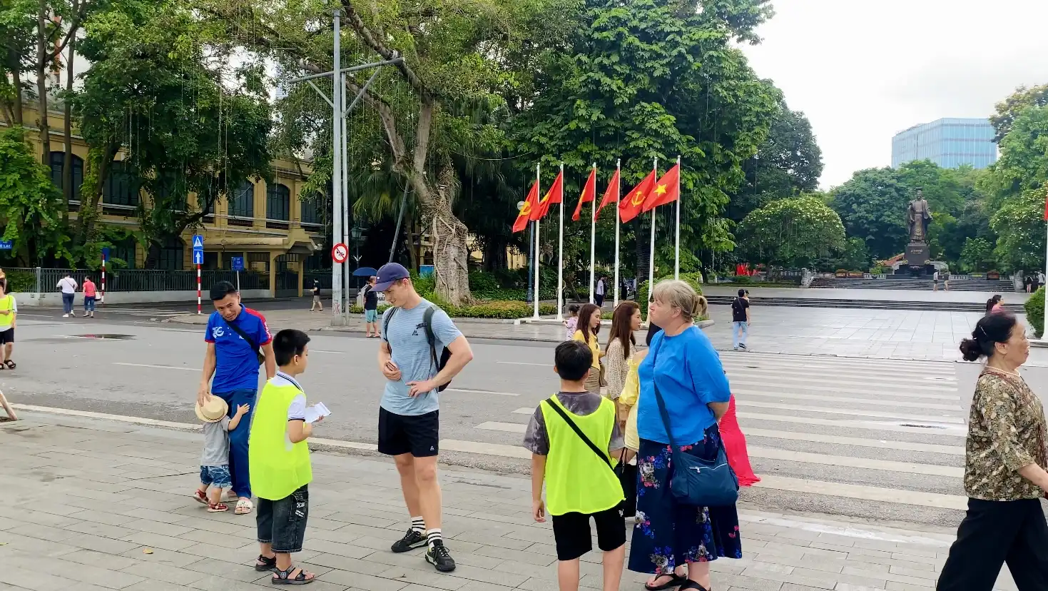 Children taking with tourists in Hanoi