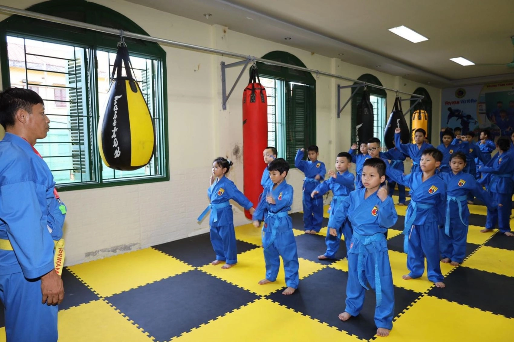 A Vovinam master teaching young kids