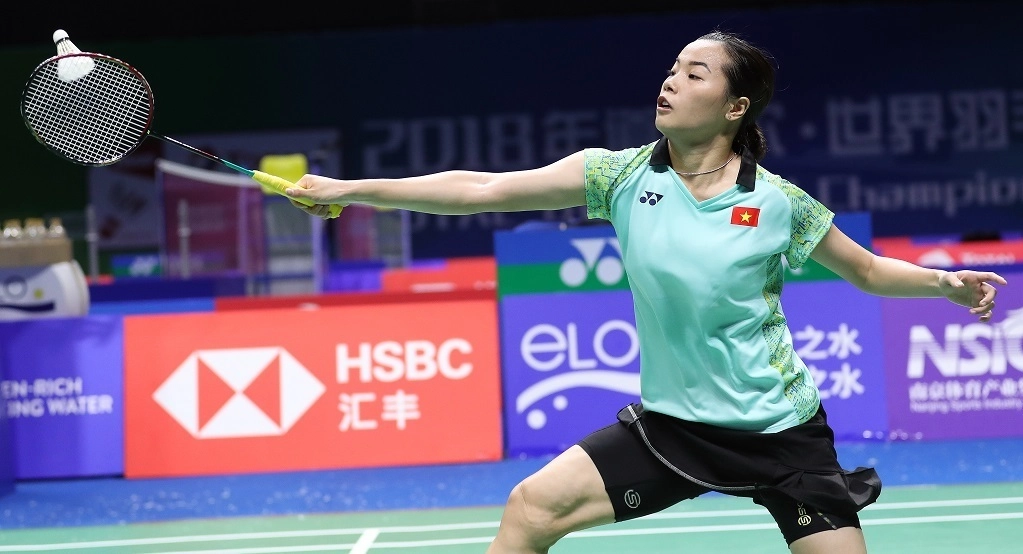 A woman badminton player in action