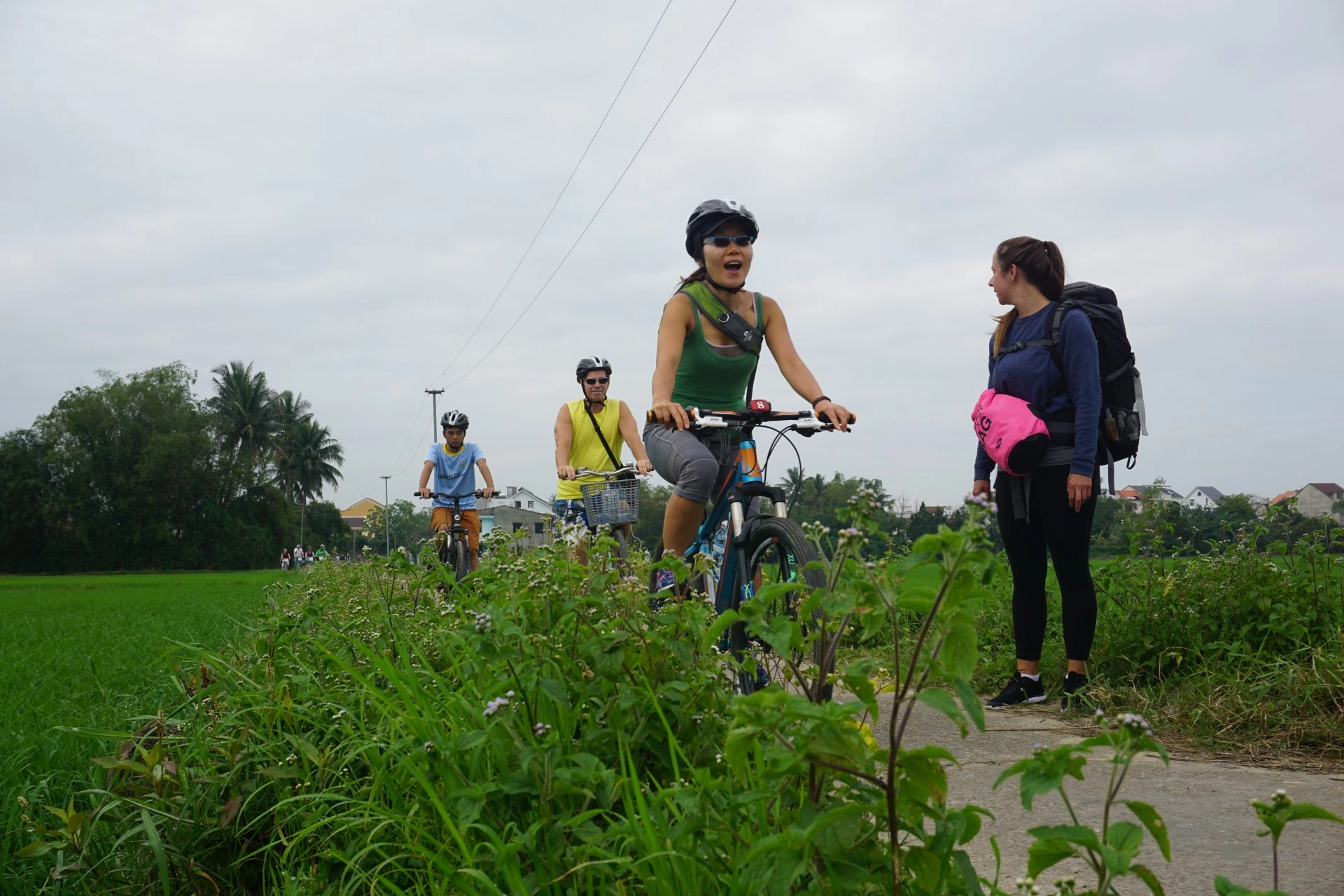 Cyclists passing village backroads